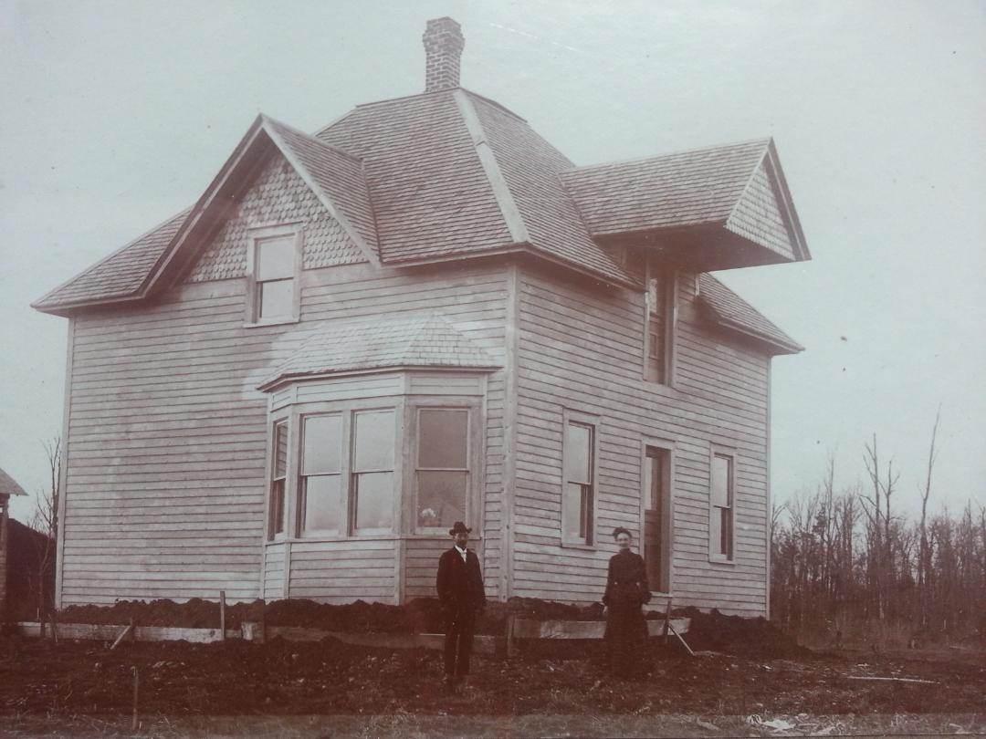 Jens Sorenson & Wife Stina. Next to a house they owned in Stanley, Wisconsin 1901-1905